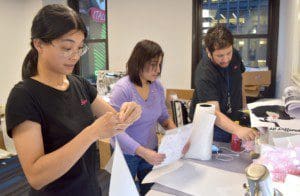Mei Zhi Zhaung with Job Coach, Elizabeth Peris, and Pascual Santiago work together at BCCO NYC