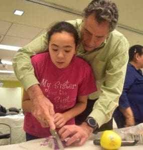 Don Celentano and his daughter Ciara chop an onion