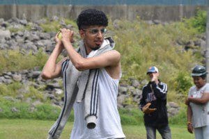 Naeem Saleh demonstrates to guests at The Lodge how to improve their softball batting stances