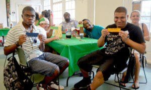 Johnny Hilario, Susana Torres, Julius Kirkpatrick, William Creighton, Tatyana Romanova, Employment Skills Coordinator, and Juan Reynoso show off their hand-made bookmarks