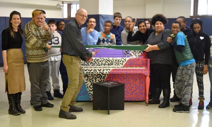 Principal Andrew Winfrey and students pose with Jennifer Kakaletris Boyar