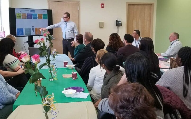 Marco discusses new AHRC NYC Initiates with staff at Dorothy and Michael Styler Day Services