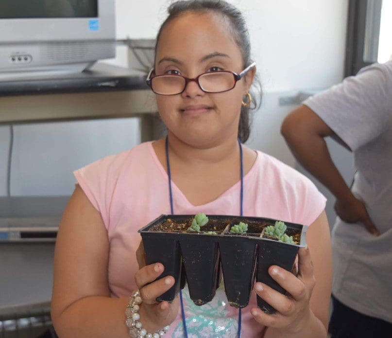 Noemi Andeliz with one of the plants she is caring for