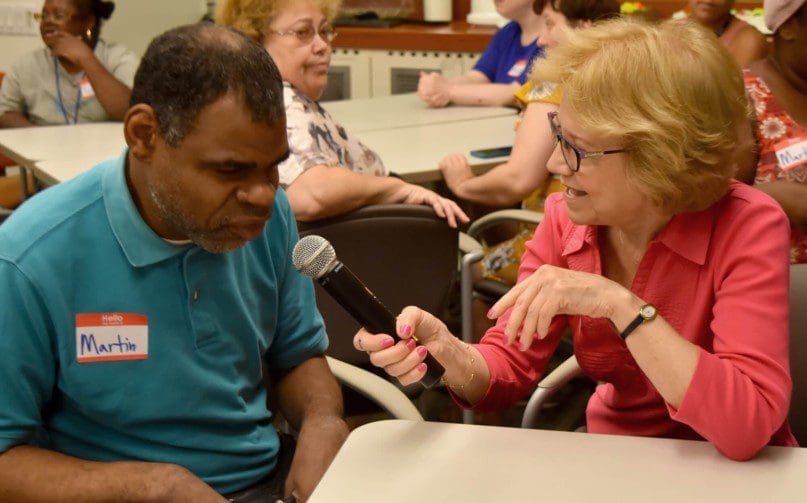 Sandra Rumayor, a book club volunteer, with Martin Neal from Walter and Evelyn Redfield Center