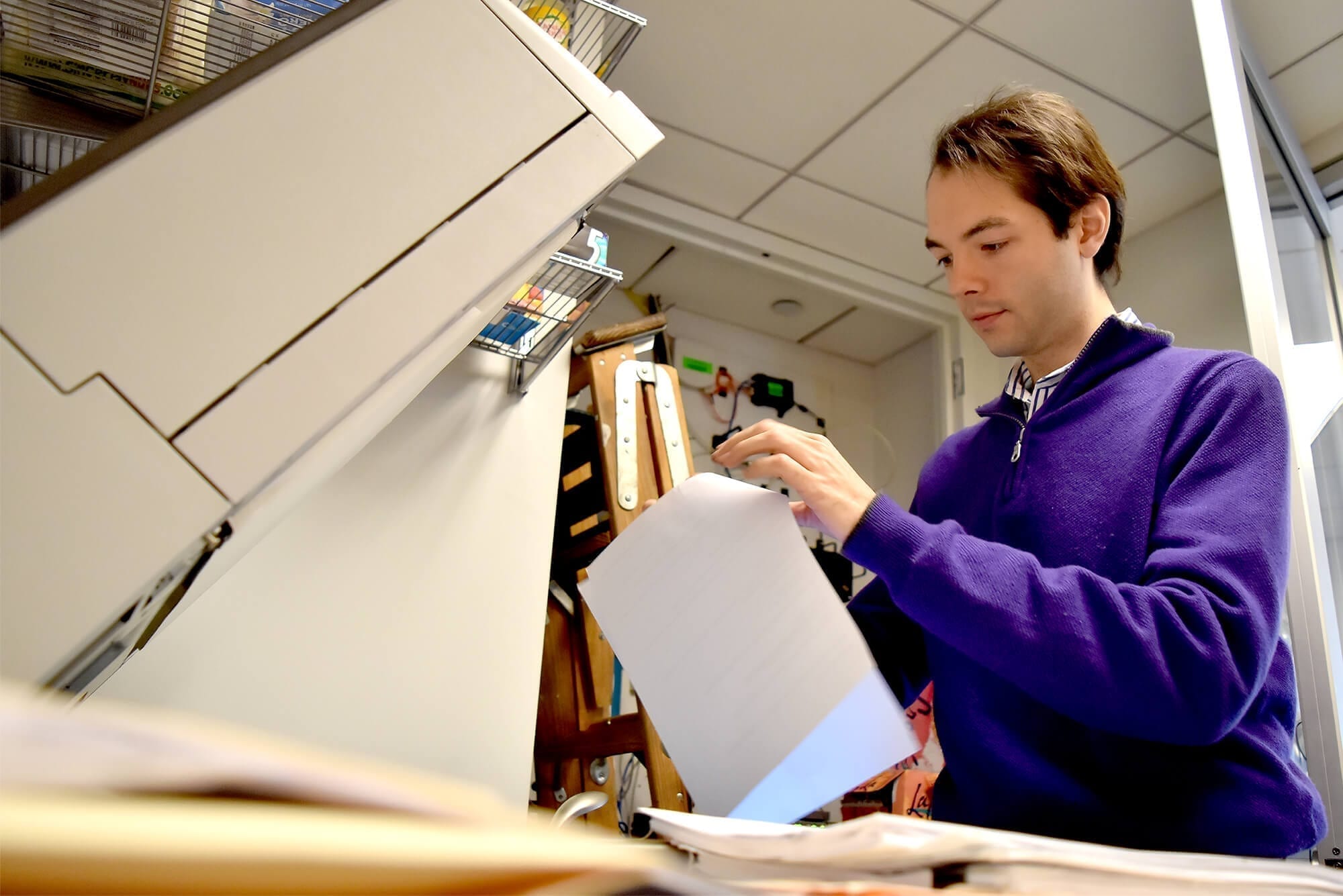 Luke Weber at the copy machine at Brick and Patel LLP, where he scans and digitizes legal documents