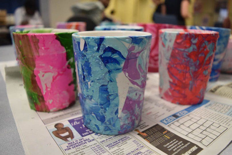 Artists at the Hudson Pre Vocation program partnered with volunteers from Salesforce to create uniquely colored mugs