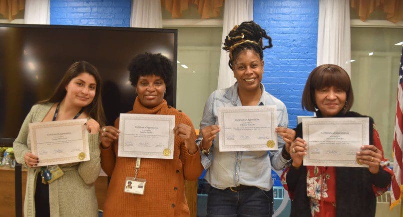 Travel trainers proudly show their certificates of appreication
