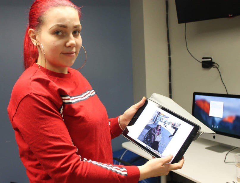 Angela Bagriy, Community Support Professionals, shows pictures of her trip into the community with Suada Shamkalova