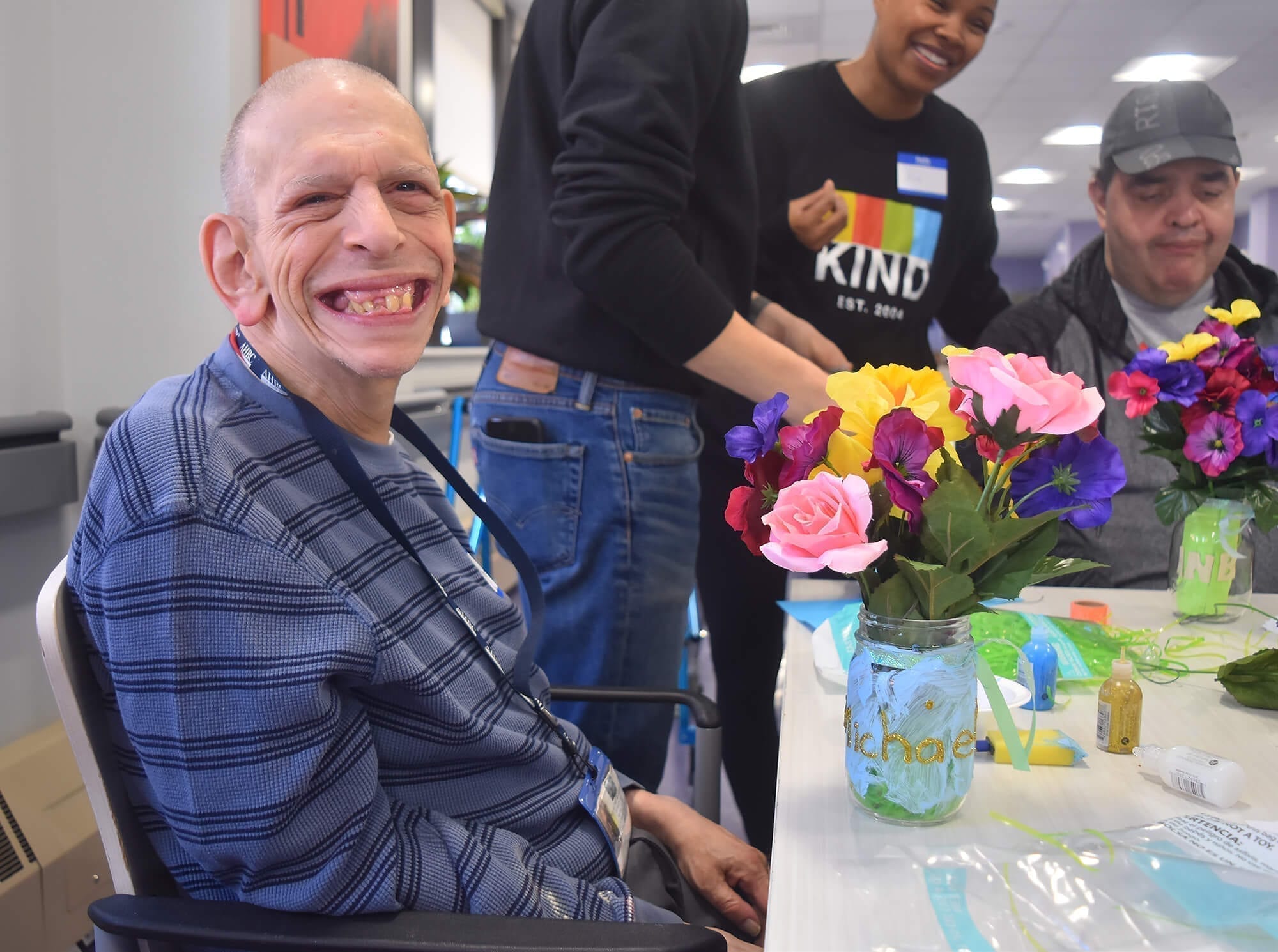 Michael Tirotta proudly shows off his flower vase created with KIND volunteers