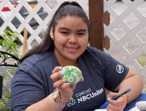 Erica Rojas painted a stone that can be used to beautify the Cyril Weinberg garden. Erica attends a Satruday program for teens at the day center.