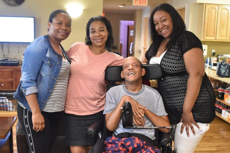 Juanita Yearwood, Nichole Tucker, and Tulina Simms with Bloomberg resident Claude Prophete