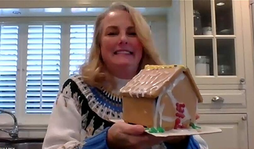 Melissa Heiss shows off her gingerbread house.