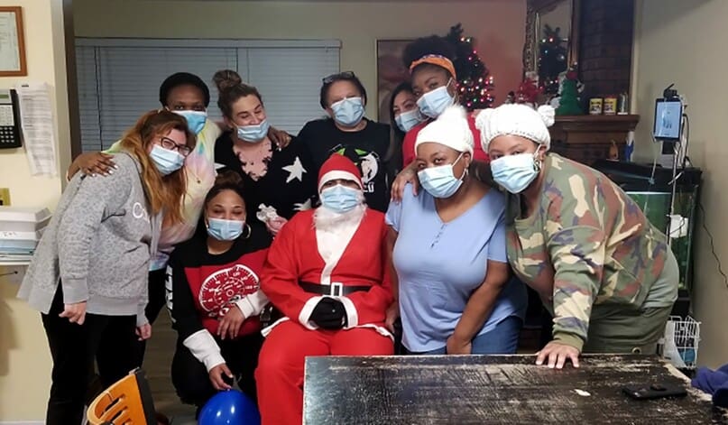 Residential Services staff members with George Sanchez as Santa