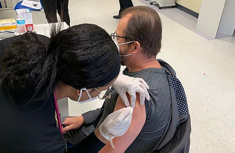 Marco Damiani, AHRC NYC's CEO, getting the COVID vaccine