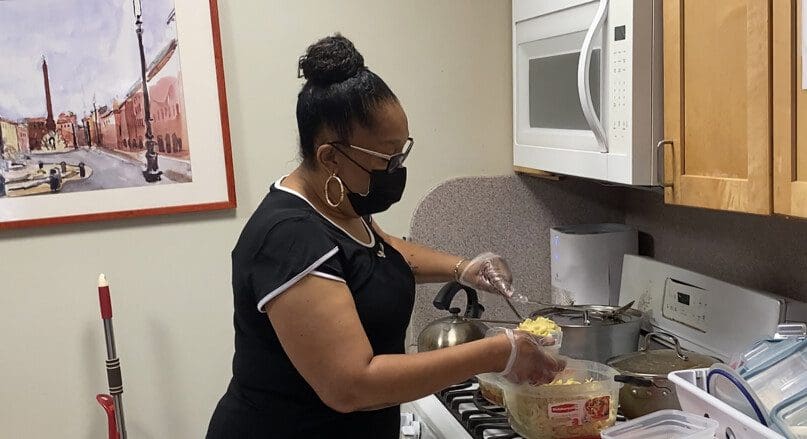 Theresa Williams Wiggins prepares lunch for the residents at Bloomberg Apartments.