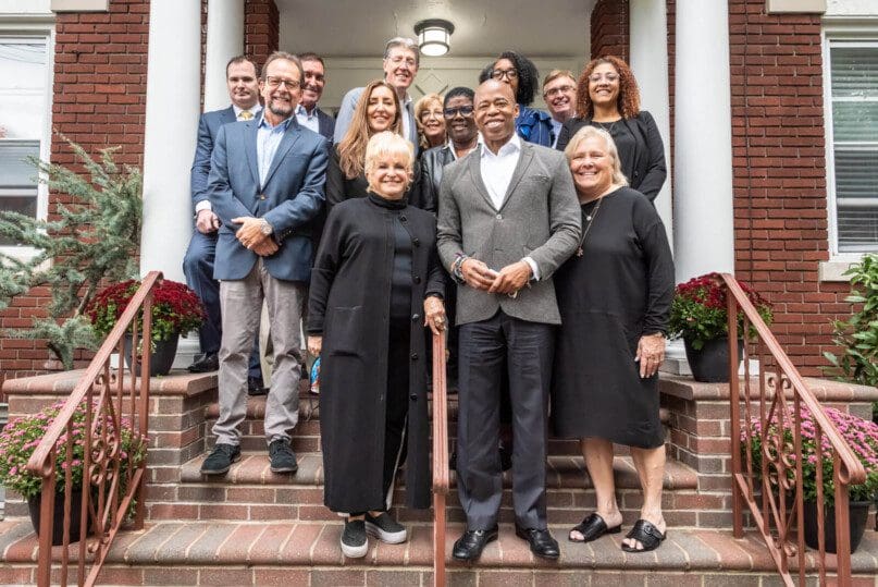 Democratic mayoral candidate and Brooklyn Borough President Eric Adams and Victoria Schneps (front) pose for a photo with healthcare leaders at Life’s WORC group home in Little Neck. (Photo by Gabriele Holtermann)