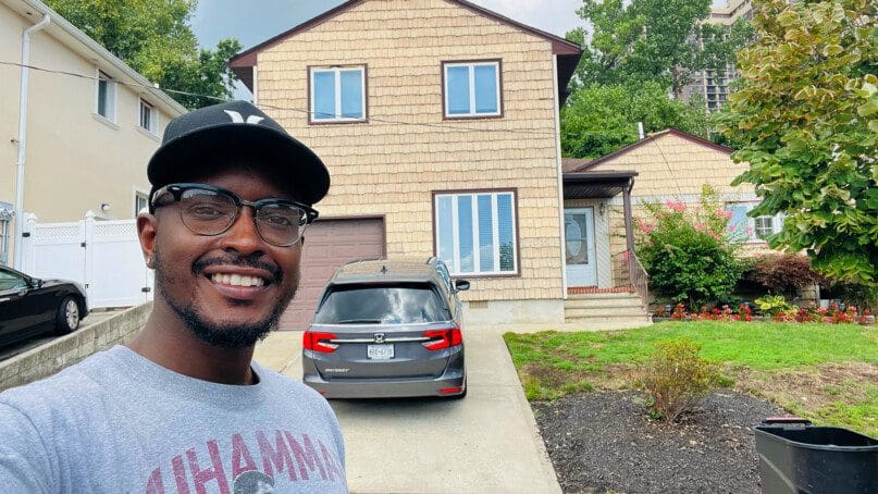 Akeem Hill in front of Glen Oaks residence, where is he is the Manager.