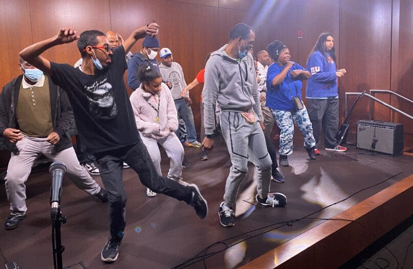 Ervine Haskins leads his peers in a dance routine at the Brooklyn Public Library's Dweck Center