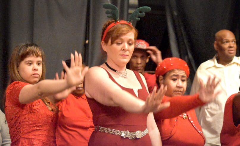 Cheryl Nelson, CSP, leads the performers in a holiday themed dance