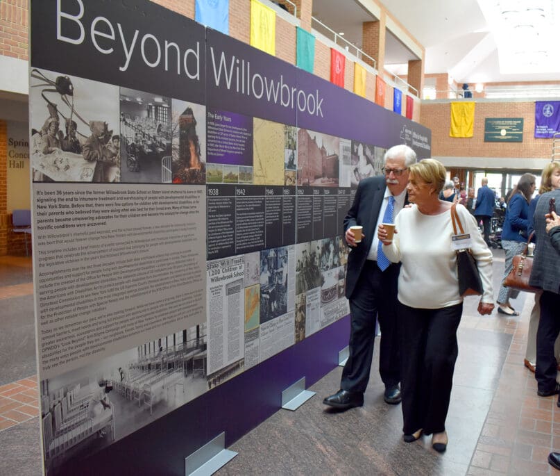 Attendees of the event study a timeline of the Willowbrook School