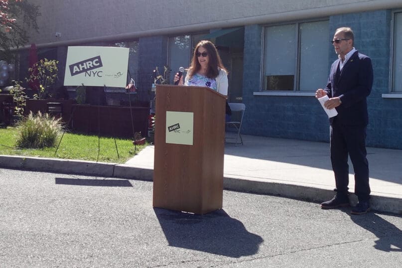 Linda Schwartz speaks to guests during the Howie & Bill Stone Day Center renaming ceremony