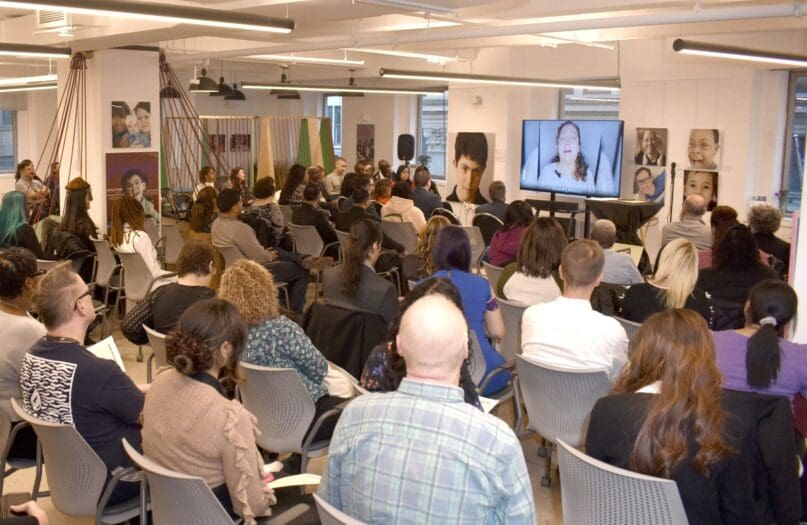 Attendees watch a video of AHRC NYC staff members describing their experiences in the NADSP pilot program