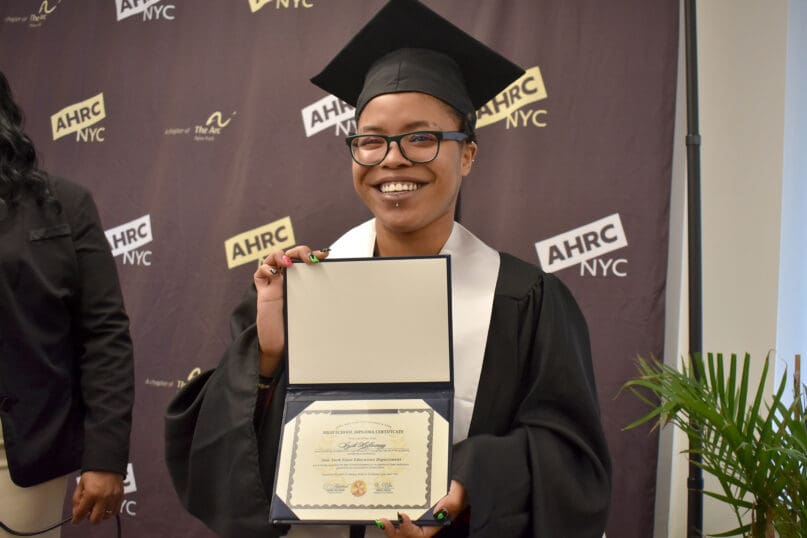 Indeira Halloway receives their High School Equivalency diploma