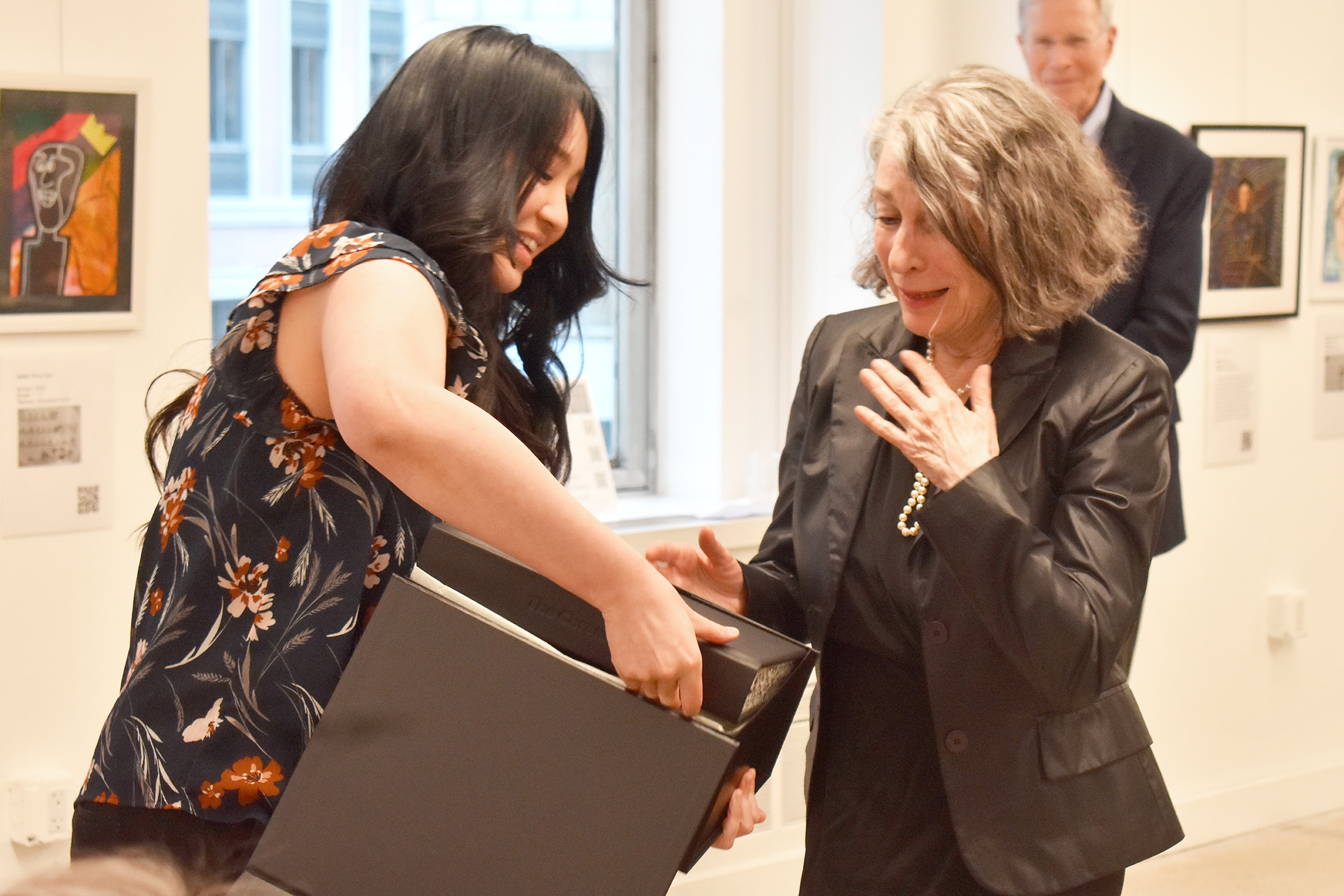 Angela Chan presents Shirley Berenstein with a bound copy of all the printed copies of the Chronicle.