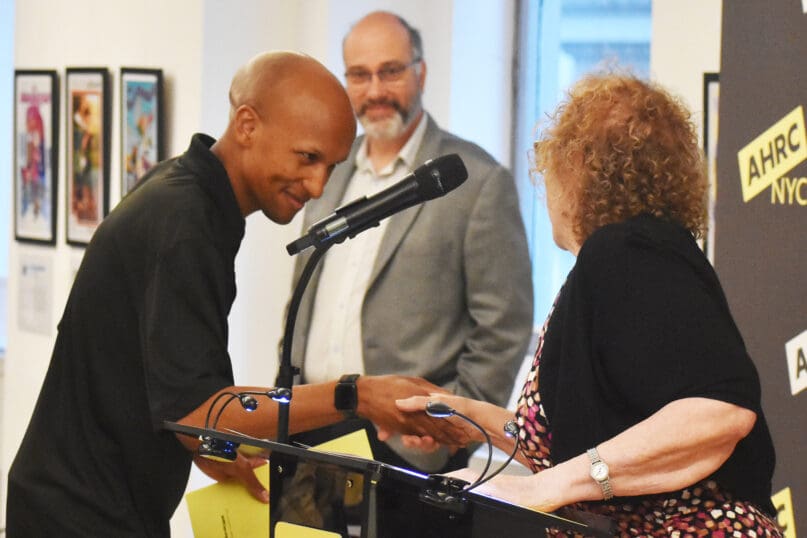 Tony Pinckney shakes hands with Meri Krasner
